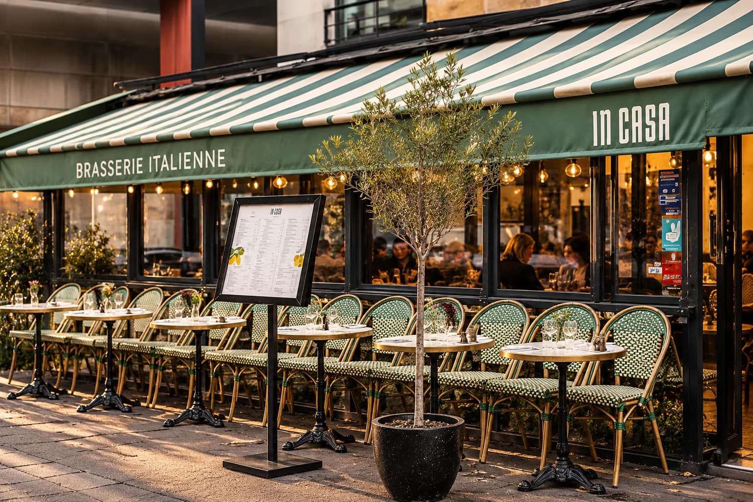 In Casa terrace, green rattan chairs and striped awning, on rue Desaix.